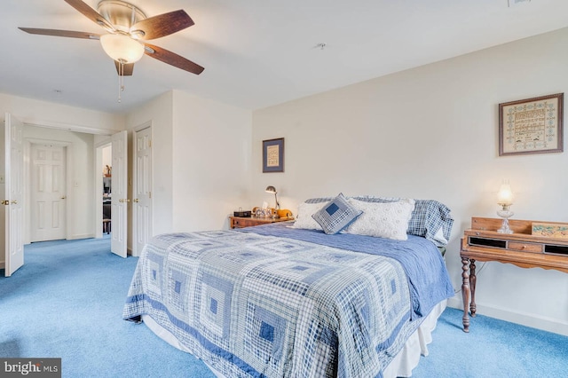 bedroom featuring light colored carpet and ceiling fan