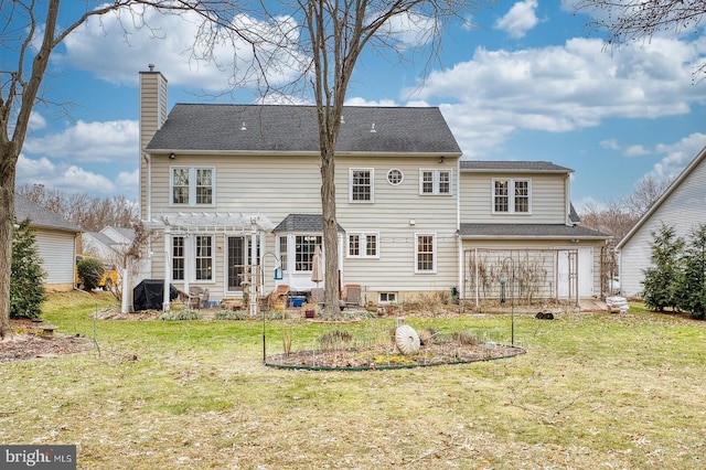 rear view of property with a yard and a pergola