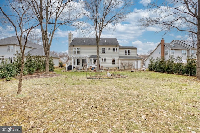 back of house with a yard and a pergola