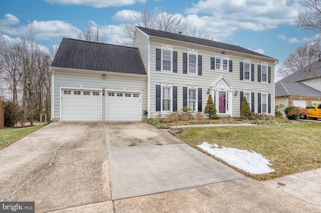 colonial home with a garage and a front lawn