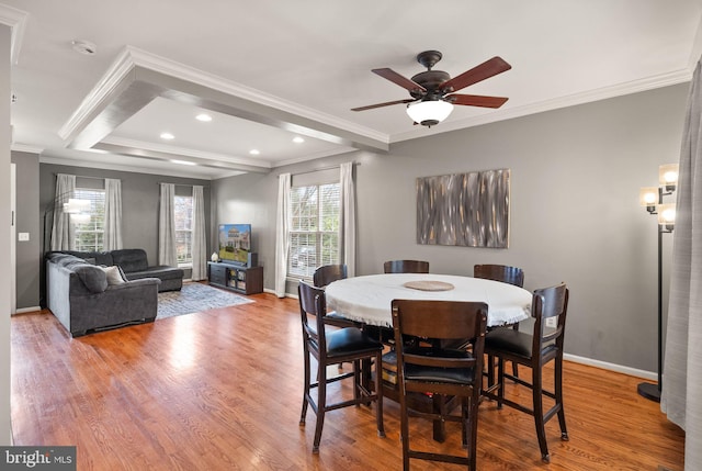 dining room featuring hardwood / wood-style floors, crown molding, and ceiling fan