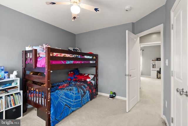 bedroom featuring ceiling fan and carpet