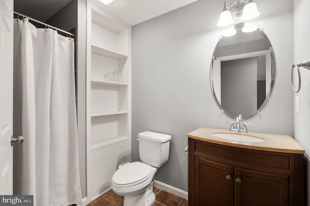 bathroom featuring tile patterned flooring, vanity, and toilet