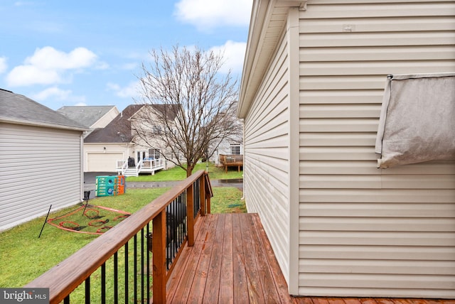 wooden terrace with a lawn