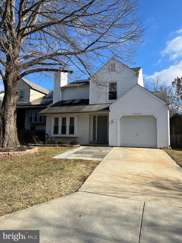 view of front of home with a garage and a front yard