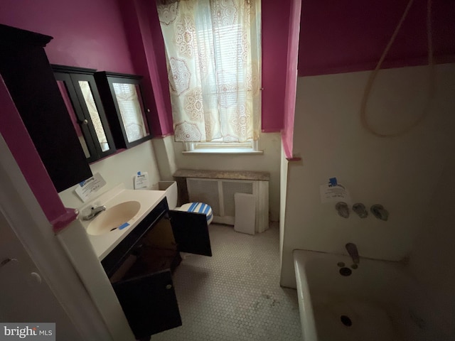 bathroom with vanity, radiator heating unit, shower / bathtub combination, and plenty of natural light