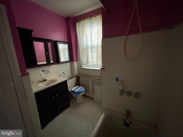 bathroom featuring vanity, radiator, and toilet