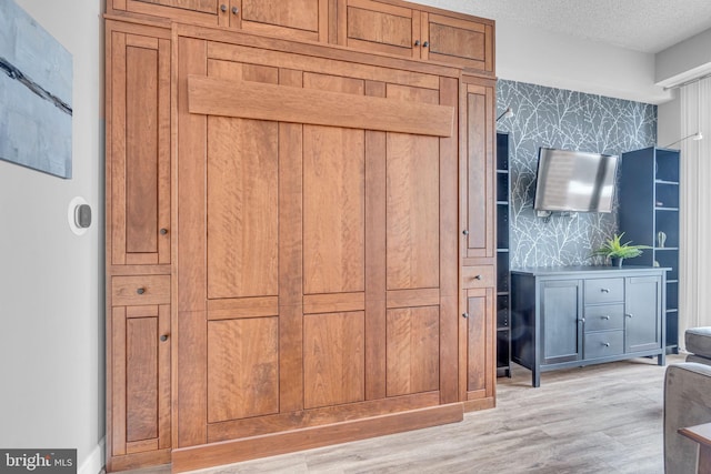 interior space with hardwood / wood-style flooring and a textured ceiling