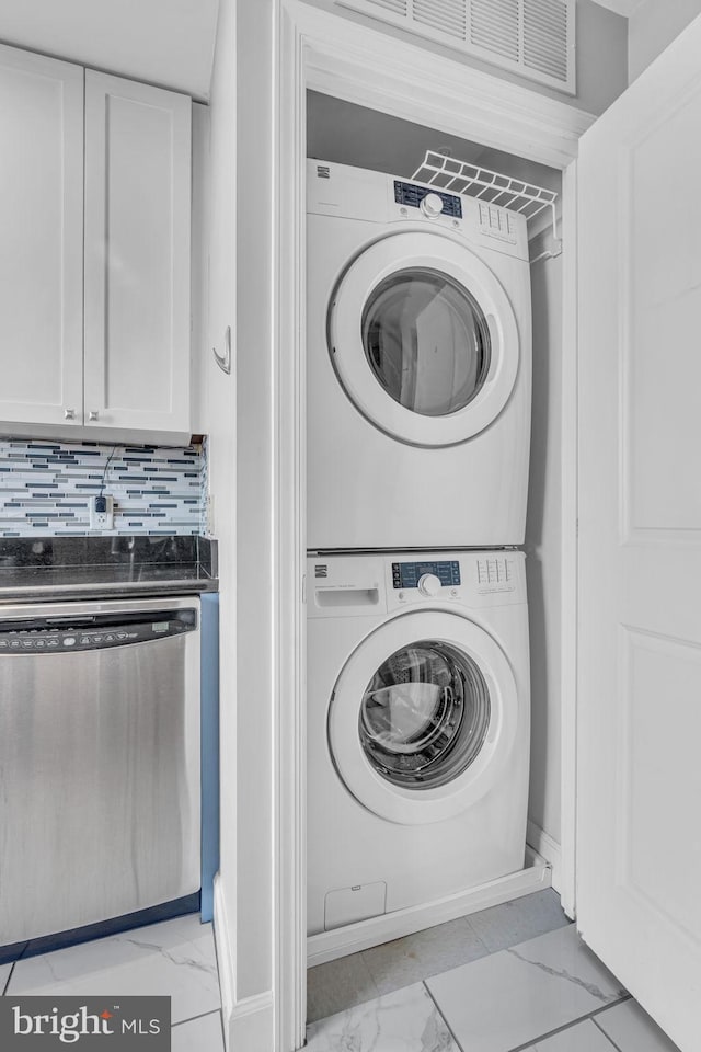 laundry area featuring stacked washer / dryer