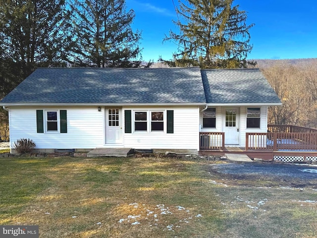 view of front of home featuring a deck and a front yard