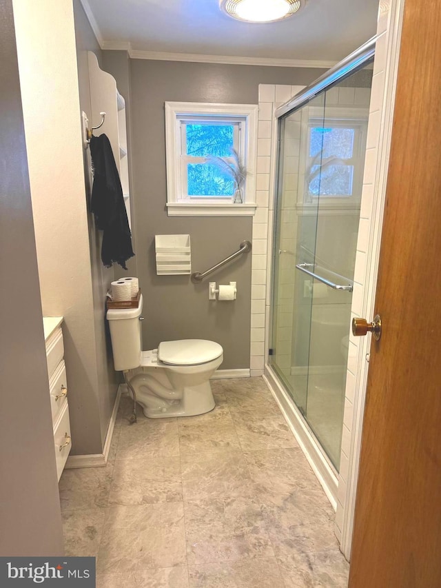 bathroom featuring crown molding, toilet, an enclosed shower, and vanity