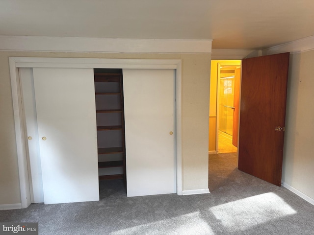 unfurnished bedroom featuring carpet and a closet