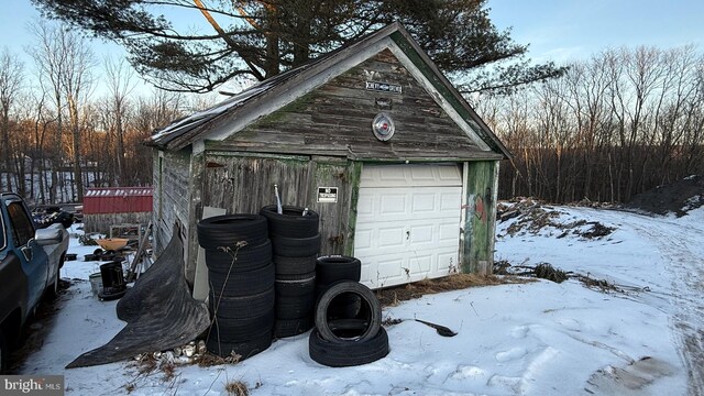 snow covered garage with a garage