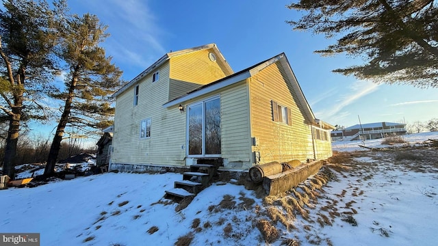 view of snowy exterior with entry steps