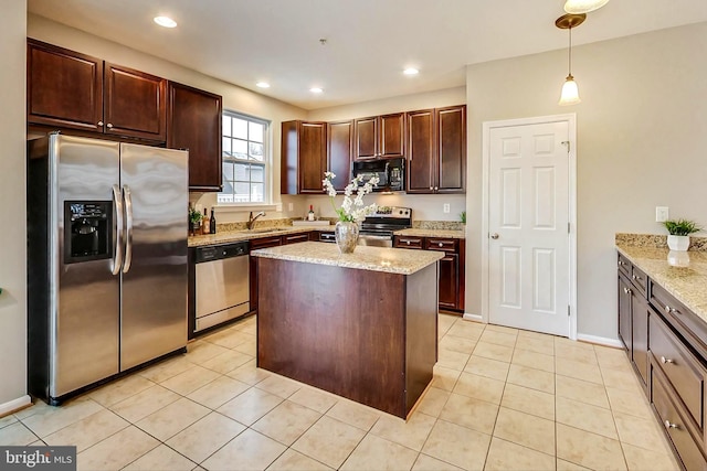 kitchen with sink, hanging light fixtures, light tile patterned floors, appliances with stainless steel finishes, and light stone countertops