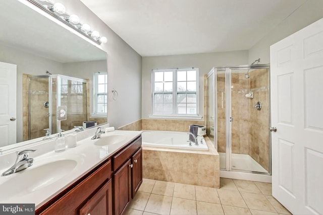 bathroom featuring tile patterned flooring, plus walk in shower, and vanity