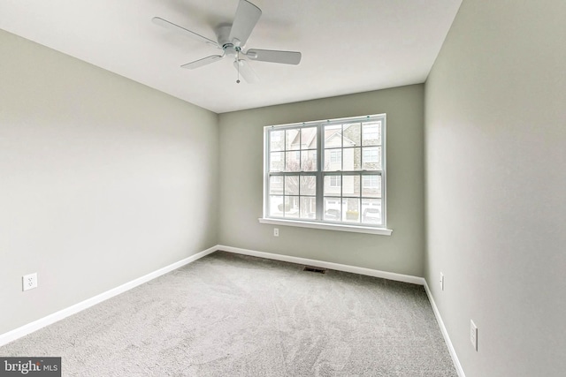 spare room featuring ceiling fan and carpet floors