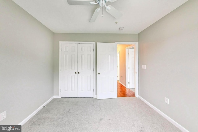 unfurnished bedroom with light carpet, ceiling fan, and a closet