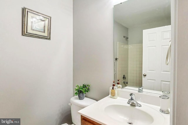 full bathroom featuring vanity, toilet, and tiled shower / bath combo