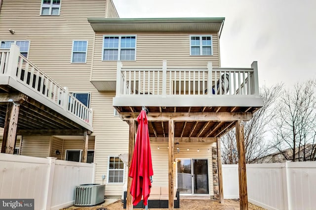 rear view of property with central AC unit