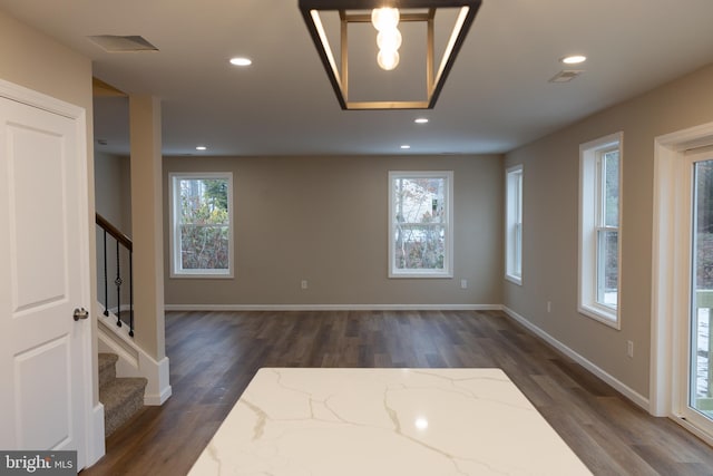 interior space with stairs, plenty of natural light, dark wood finished floors, and recessed lighting