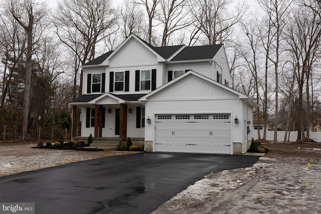 view of front of property with aphalt driveway and an attached garage