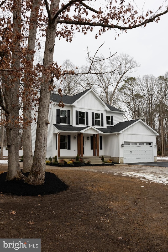 modern inspired farmhouse with board and batten siding and an attached garage