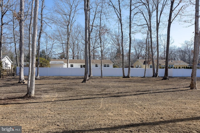 view of yard with a residential view and fence