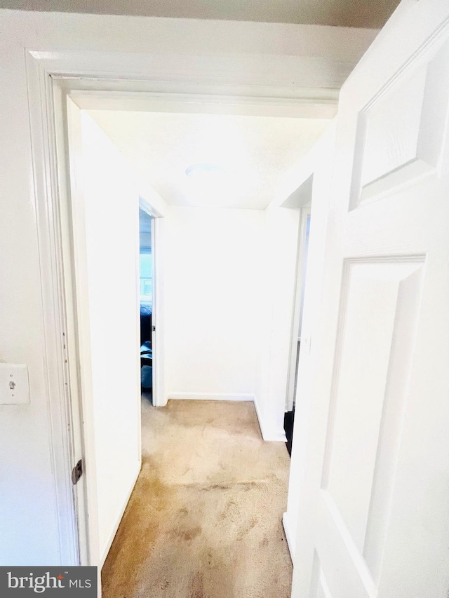 hall with carpet and baseboards