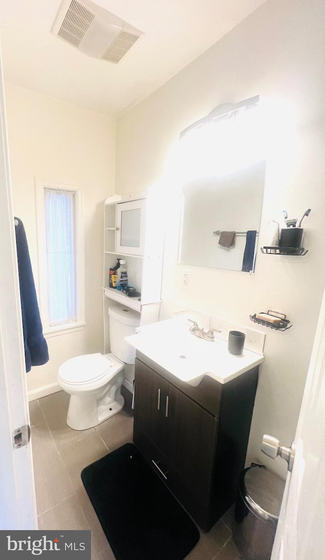 bathroom featuring visible vents, toilet, and vanity