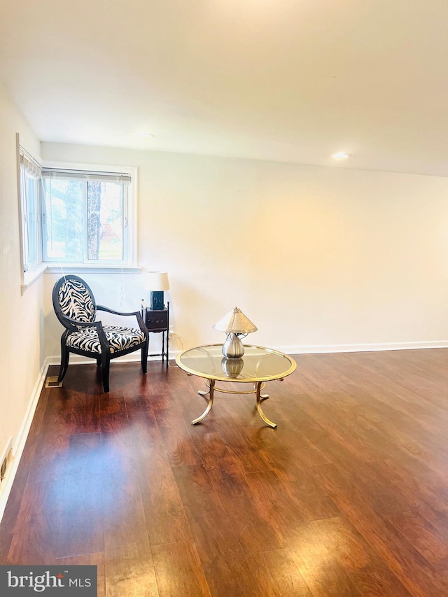 sitting room featuring baseboards and wood finished floors
