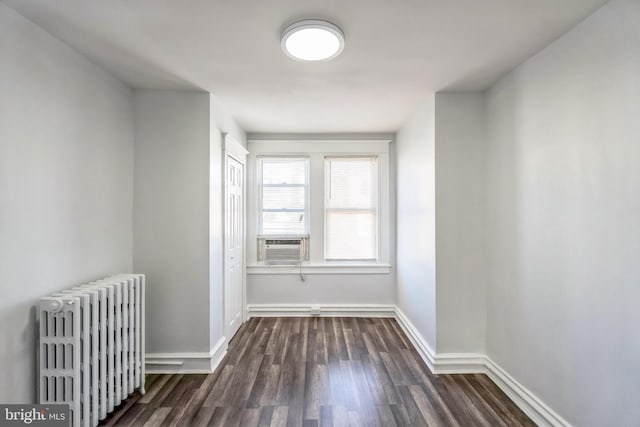 hallway with dark hardwood / wood-style flooring, radiator, and cooling unit