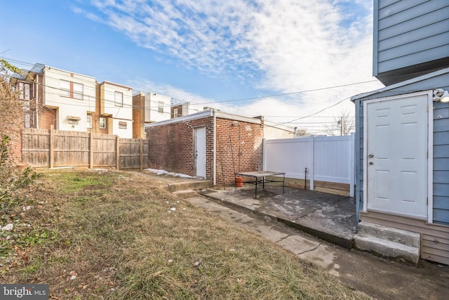 view of yard with an outdoor structure and a patio area