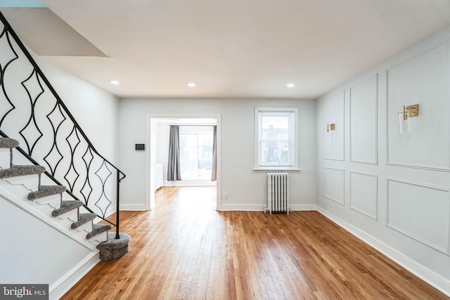 foyer with radiator and light hardwood / wood-style flooring