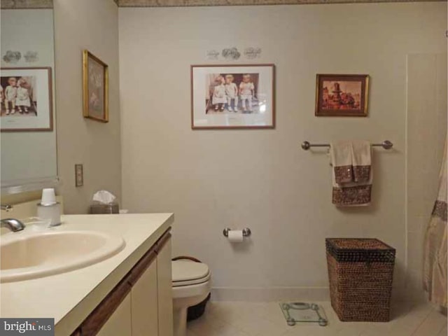 bathroom featuring vanity, tile patterned floors, and toilet