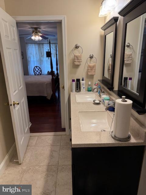 bathroom featuring tile patterned flooring, vanity, and ceiling fan