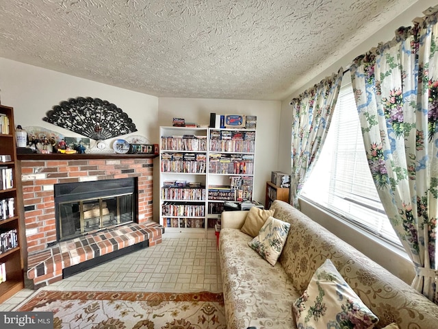 living area with a fireplace and a textured ceiling