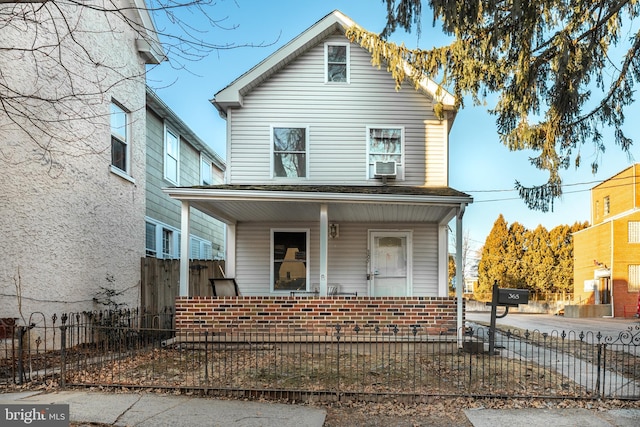 front facade featuring cooling unit and a porch