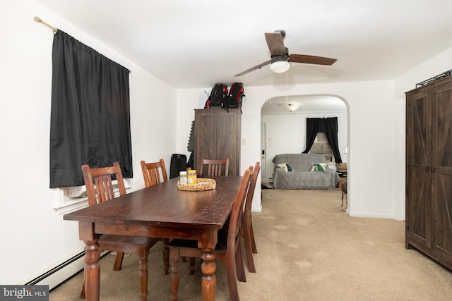 dining area with light colored carpet, ceiling fan, and baseboard heating