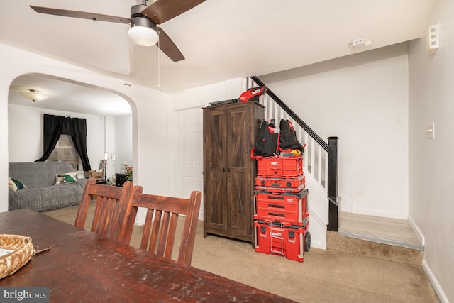 carpeted dining area featuring ceiling fan