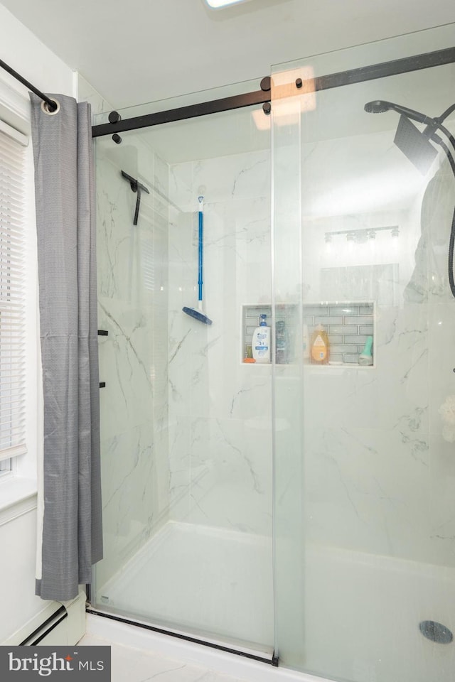 bathroom featuring a shower with shower door