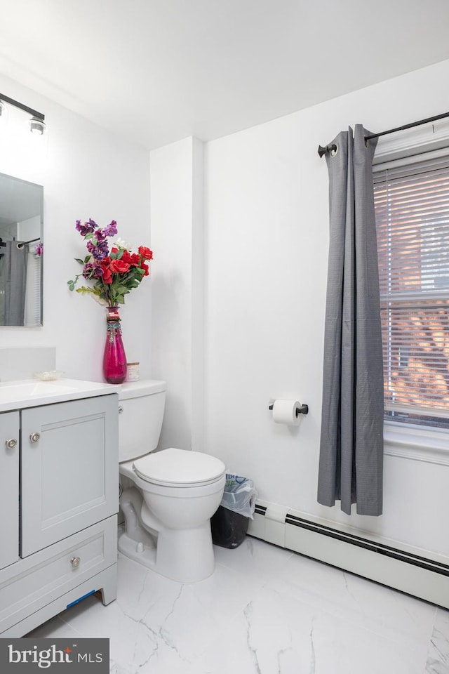 bathroom featuring a baseboard radiator, vanity, and toilet