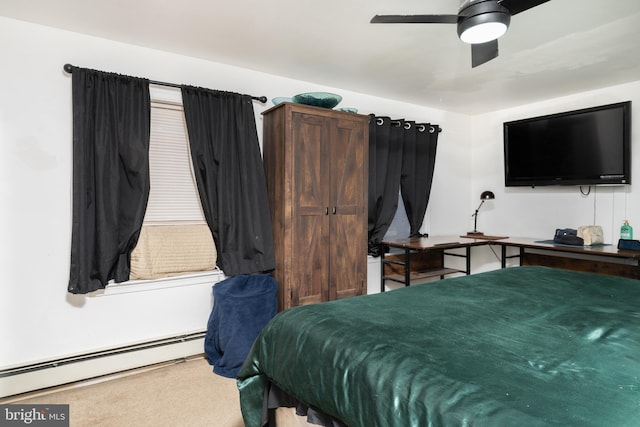 carpeted bedroom with ceiling fan and a baseboard heating unit