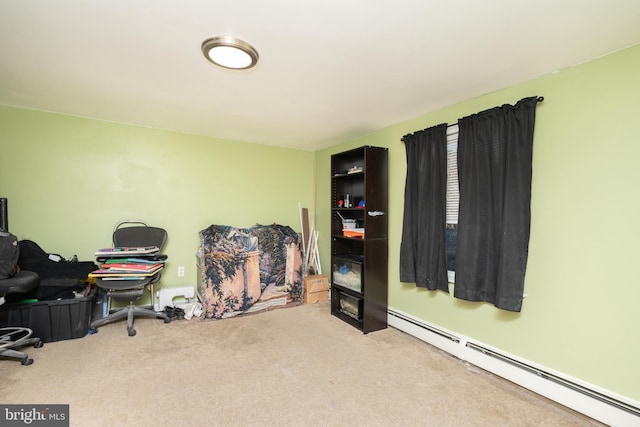 office area with a baseboard heating unit and carpet