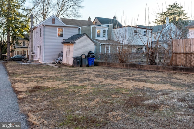 rear view of house featuring a lawn