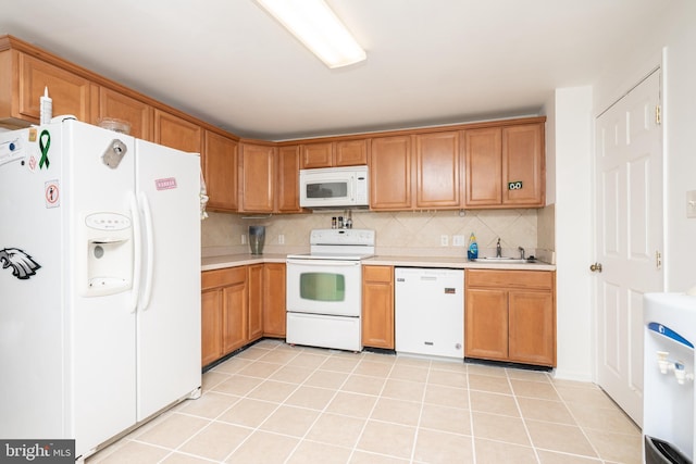 kitchen with sink, light tile patterned floors, backsplash, and white appliances