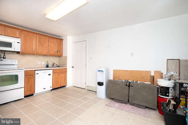 kitchen featuring sink, light tile patterned floors, backsplash, and white appliances