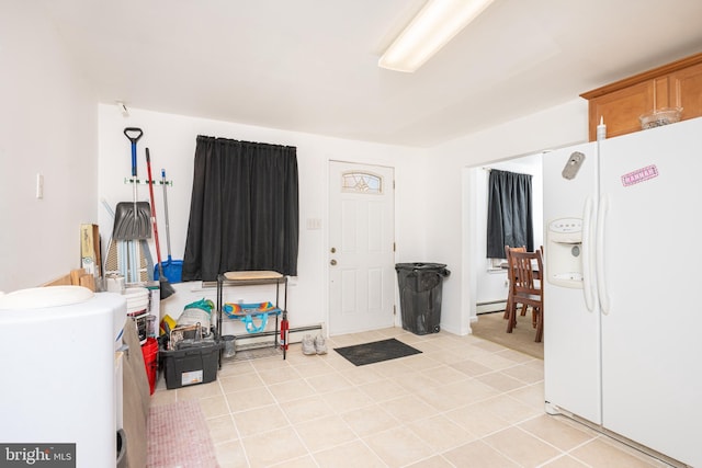 misc room featuring a baseboard heating unit and light tile patterned flooring