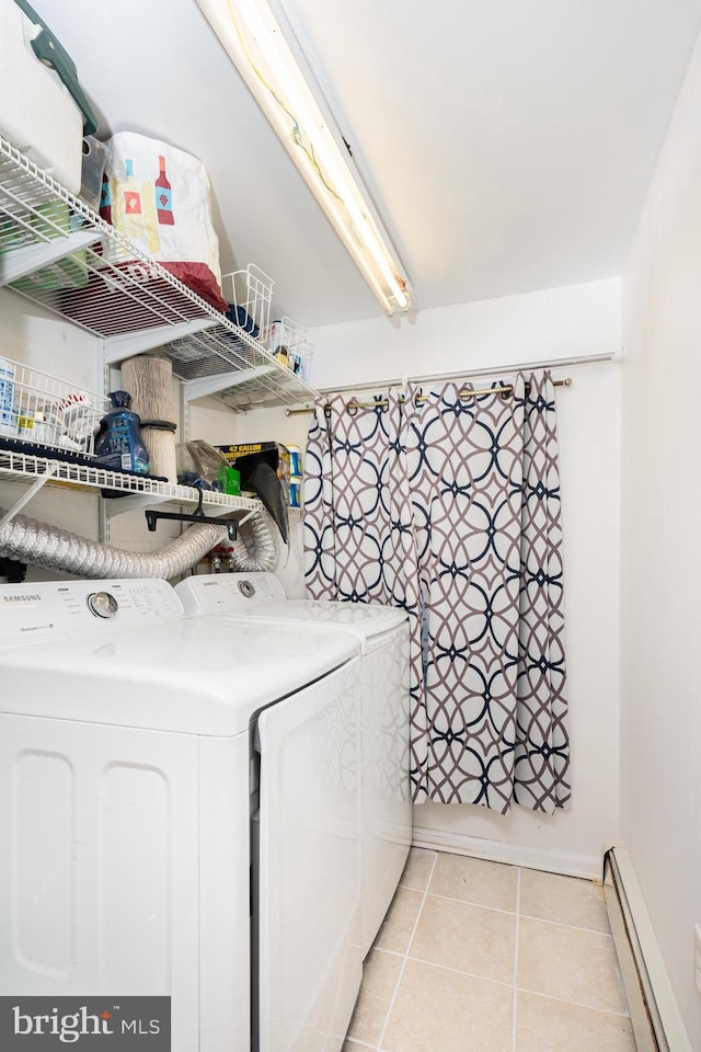 laundry area featuring a baseboard radiator, washer and clothes dryer, and light tile patterned floors