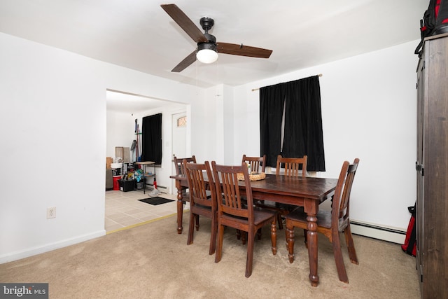 dining area featuring light carpet, a baseboard radiator, and ceiling fan